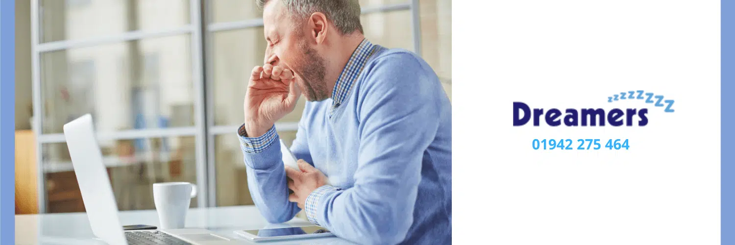 Man yawning due to tiredness in the afternoon